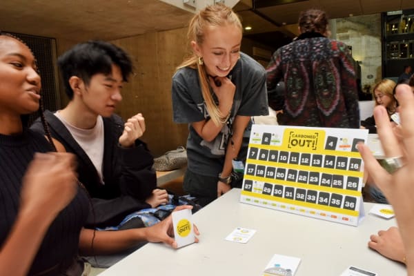 A group playing a board game called Carboned Out