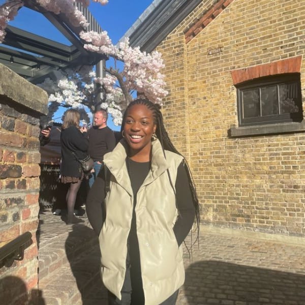 Image of student standing with hand in pocket