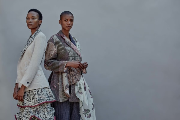 Two models wearing knitted garments