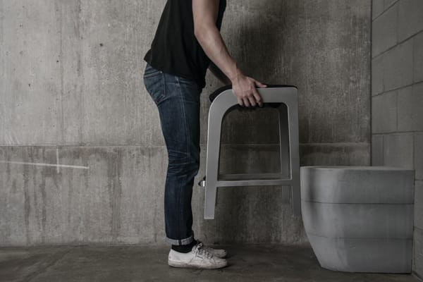 Man holding furniture over toilet