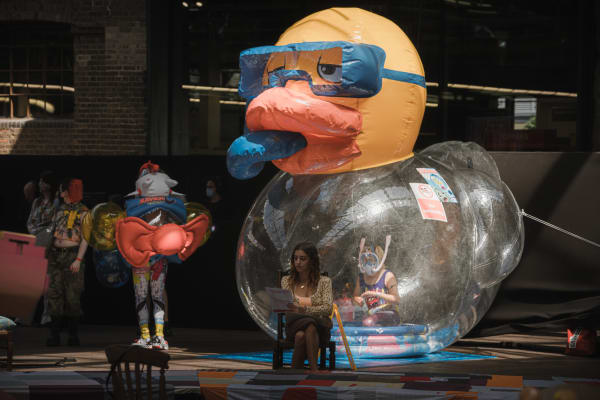 Space laid with patchwork quilt on winding catwalk and giant rubber duck