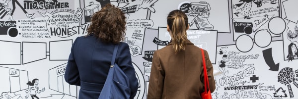 Two people staring at a graffiti