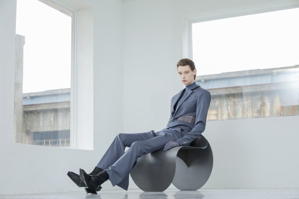 Model on chair in tailored garments