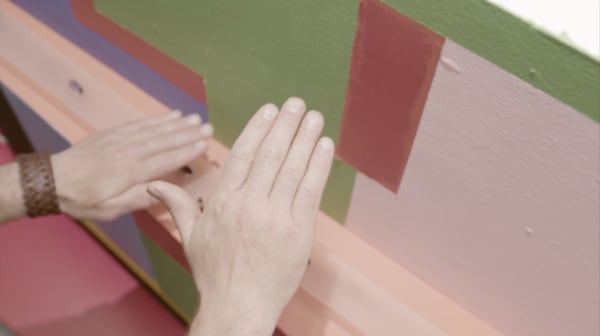 Hand playing with Yidan Xu's Divergence of Normalities Interactive Sound Box