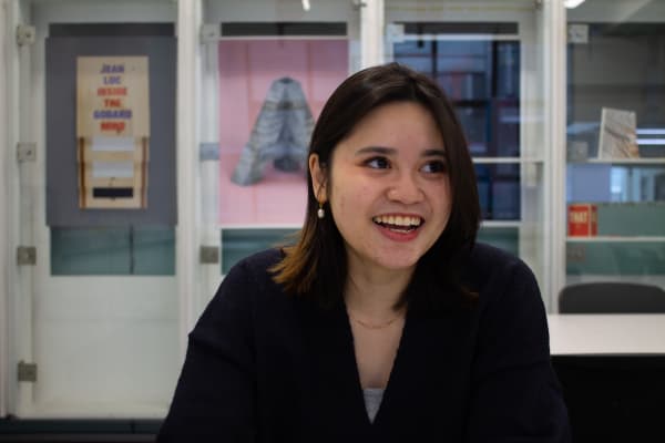 Jazmine in a classroom smiling and speaking