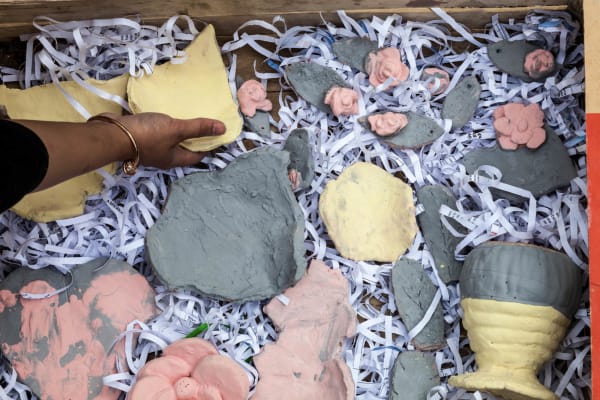 Hand reaching for clay objects
