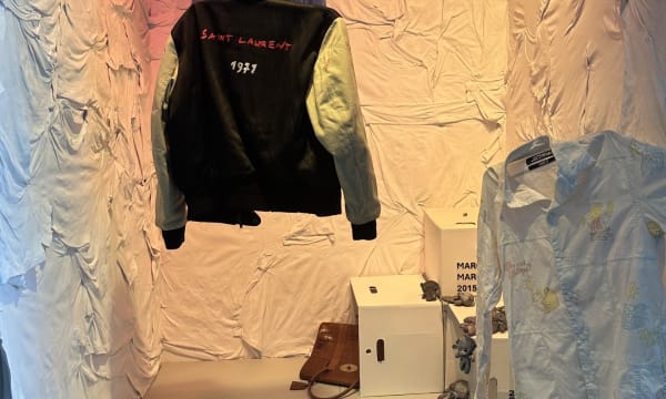 Charlie Quiney's Physical Space Show Room with clothes hanging in a white textured popup space