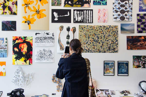 Overlapping photos of ECG printouts scattered across a computer keyboard and desk.