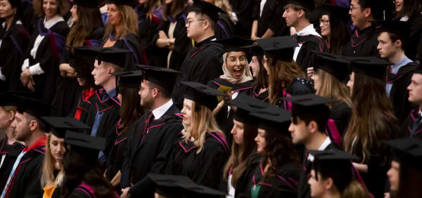 Graduating students sitting in auditorium