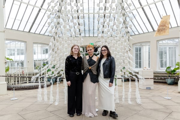 3 people smiling at camera. 