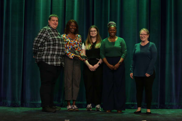 People standing receiving an award