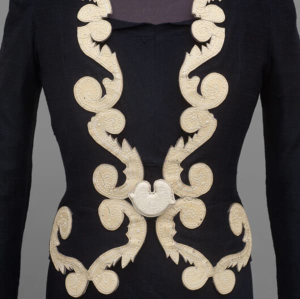 Close-up of embroidered black and cream Jacket, Elsa Schiaparelli, 1937, Manchester Art Gallery. Photography: Michael Pollard.