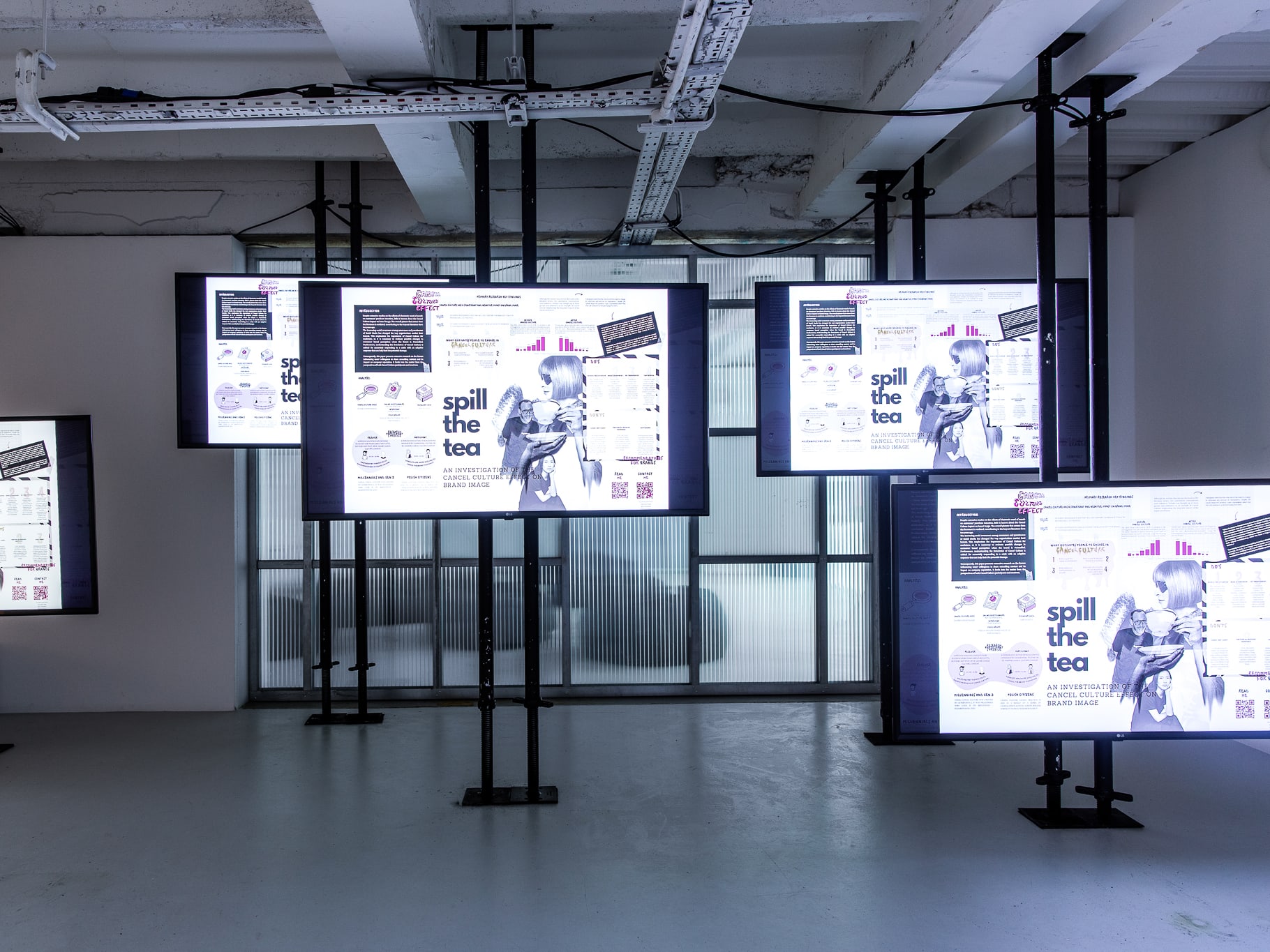 Digital installation showing student work across multiple screens.