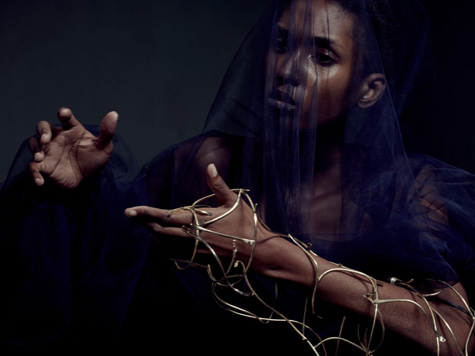 Female model with gold jewellery on her wrist