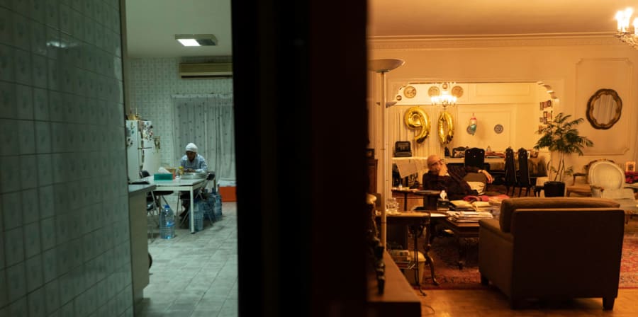 two people sitting in separate rooms 