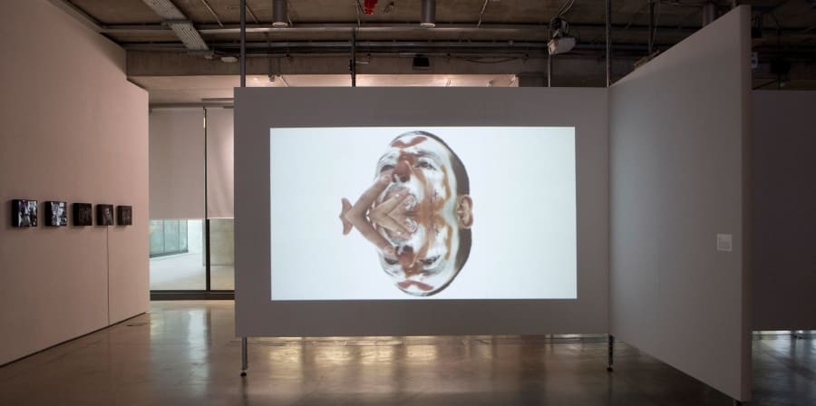 Image of a clown projected onto a large wide wall