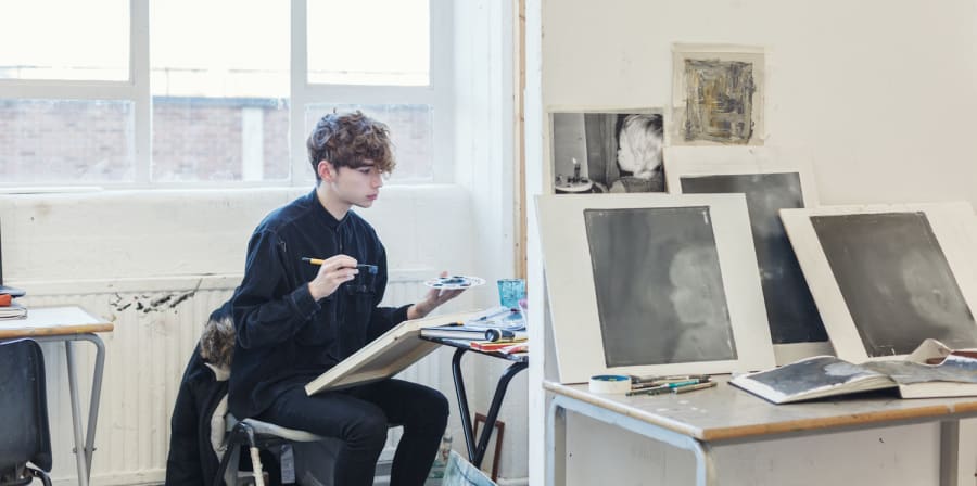 A student sat down painting
