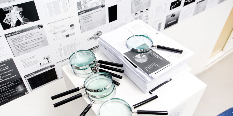 An exhibit featuring magnifying glasses and printed out images and graphs