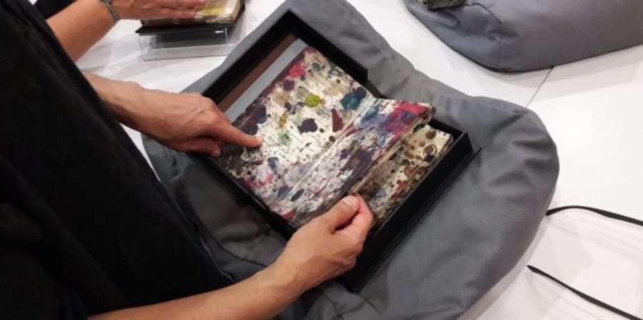 a woman points at a book from an archive