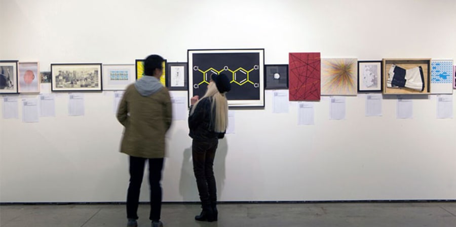 People looking at donations to the Postgraduate Art Auction on display in the Lethaby Gallery