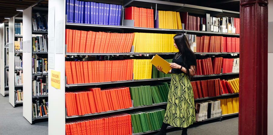 A student reading a book in the library 