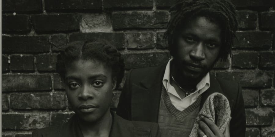 Black and white photograph, upper body portrait of two people