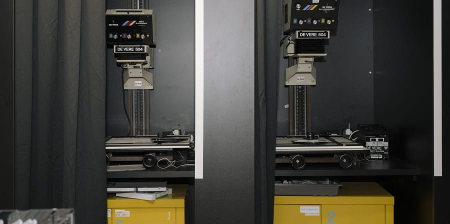Two machines behind a black curtain.