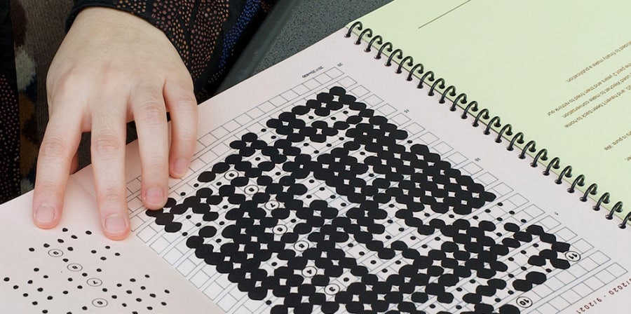Book with a grid layout of a claendar marked with small black dots. 