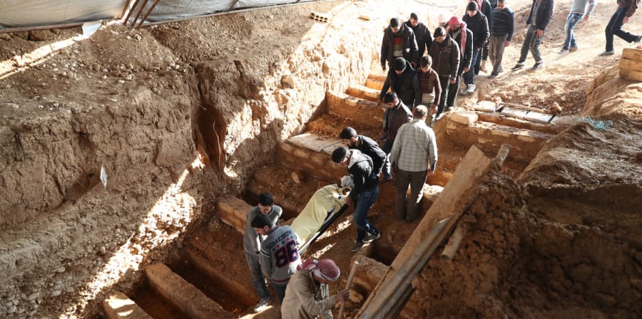Syrian workers carrying stretcher
