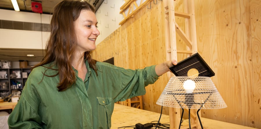 Elizabeth Harper demonstrates her Li-Fi Beacon - a multifunctional illumination and connectivity device that beams musically wirelessly via LED with the help of a refractive crystal shade. 