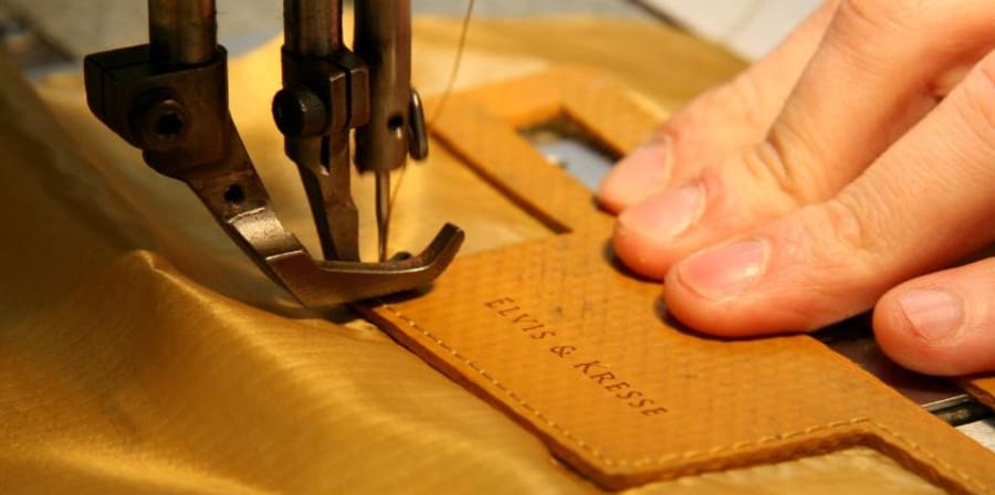Image of hand using sewing machine for a bag