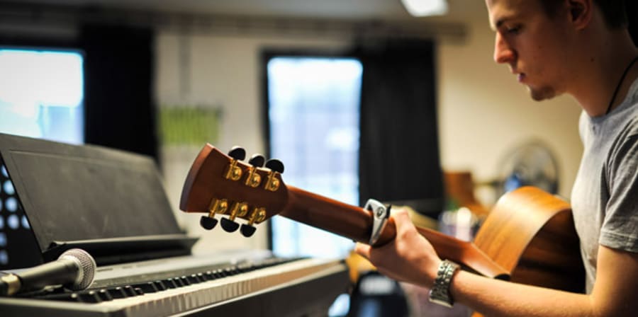 Student playing guitar