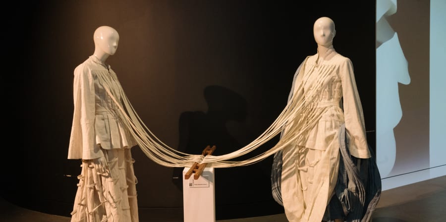 Mannequins attached by rope.