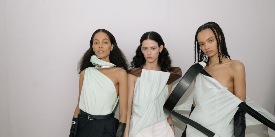 3 models in mint green gauze with furniture to create shape.