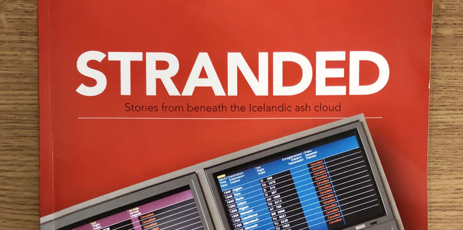 The red cover of Stranded, which features an open suitcase.