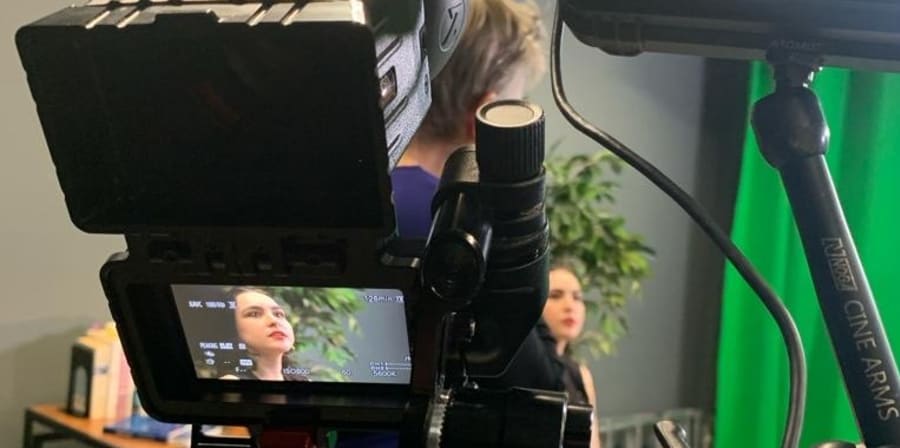 A person in front of a camera capture from behind the camera