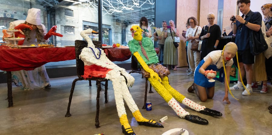 A dining scene with animal sculptures and a performance taking place