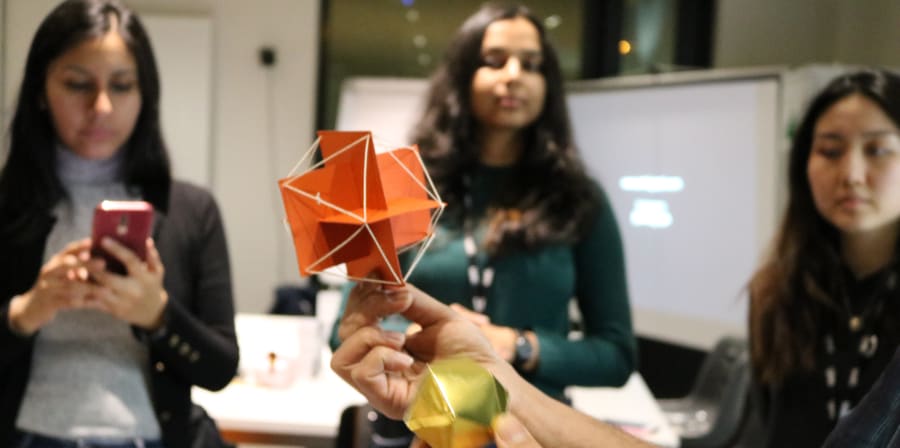 students watching an origami making demonstration