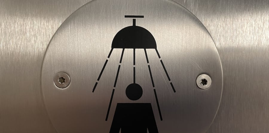 A stainless steel show sign fixed to a door 