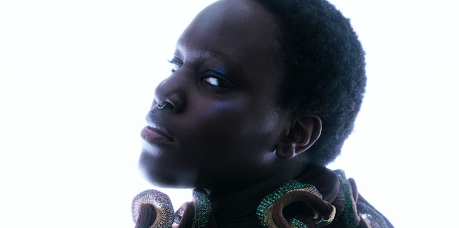 portrait of a woman in a metallic top with waves and curves