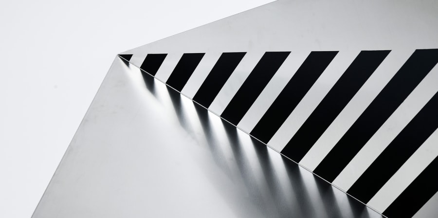 Minimalist abstract black, white and silver sculpture using metal.