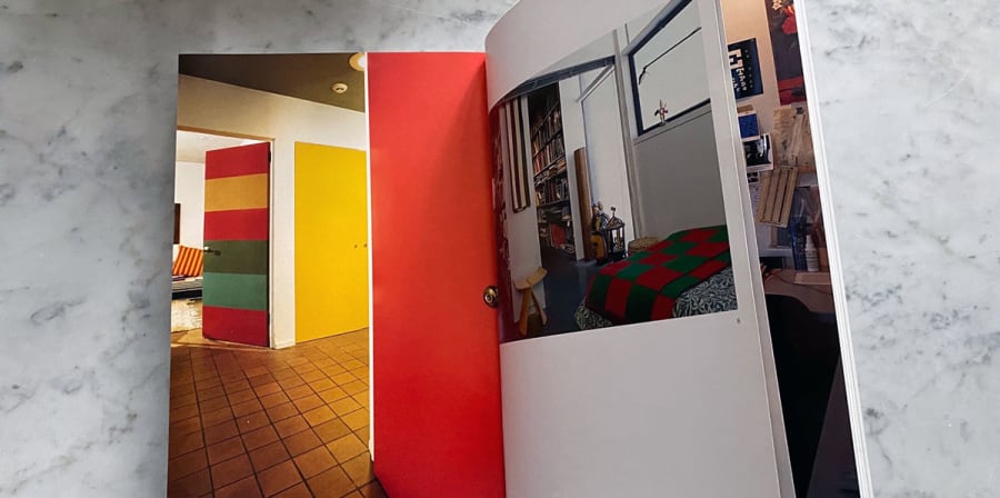A book opens to a page detailing the interior of a home.