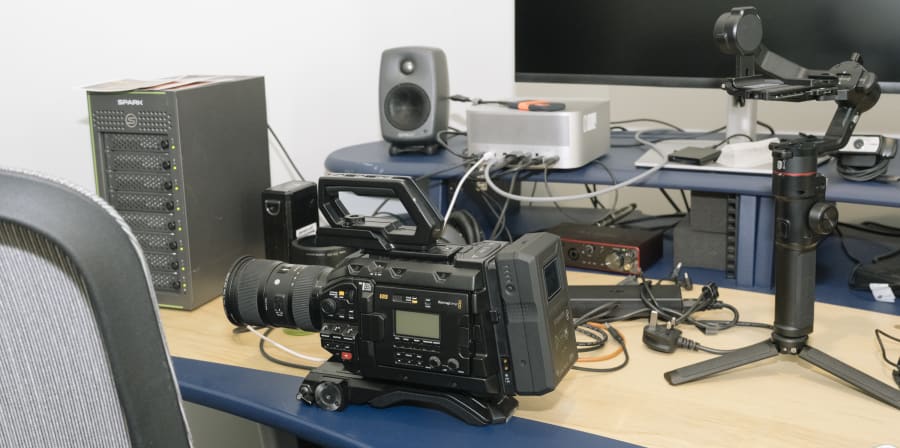 Camera, speaker, screen on a desk.