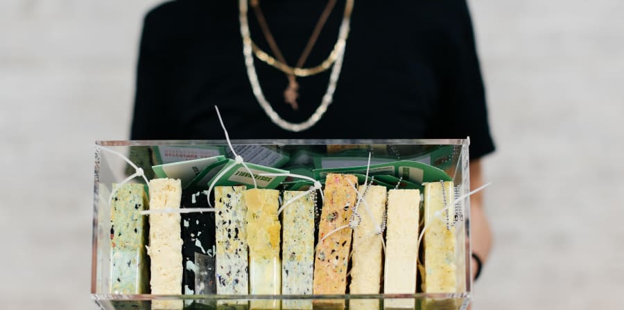 Woman holding case of materials.