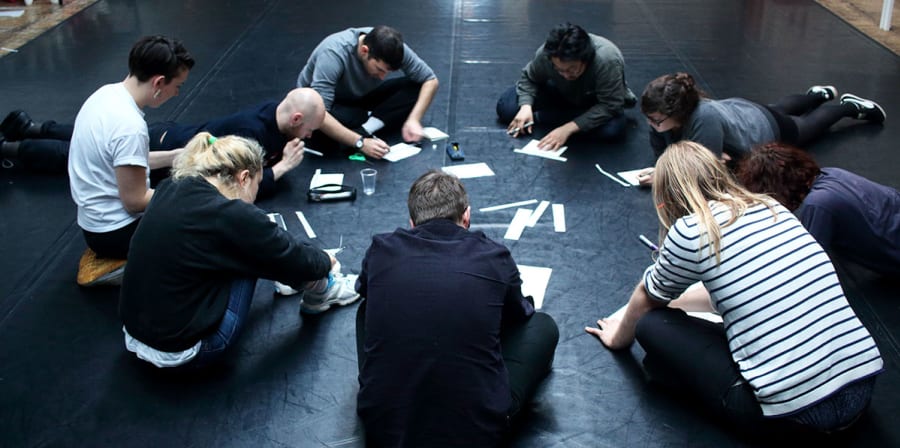 Dr Ed Webb-Ingall directs a workshop with in a group of students two students during the Tramway Festival in 2016.