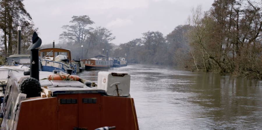 Still of a boat on a serene canal.