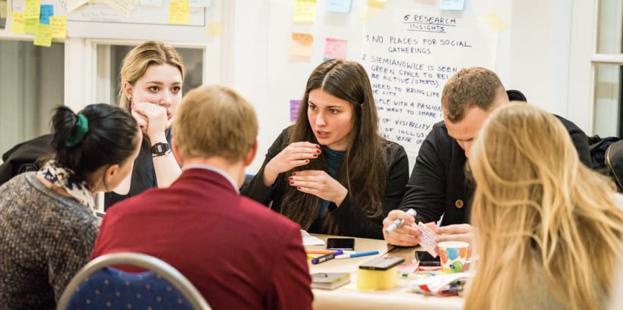 Group of students discussing ideas on a table