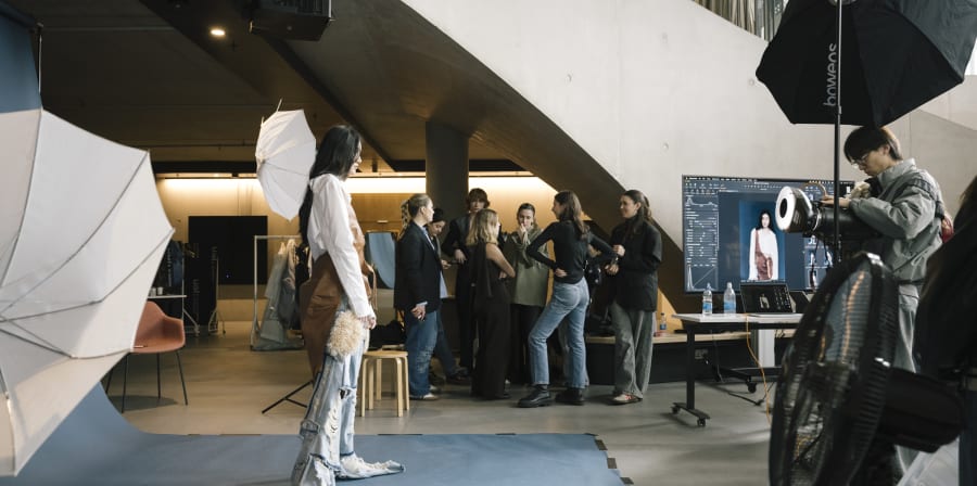 Model and photographer in the studio with guests.