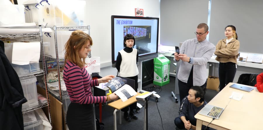Photo of UX Design students presenting design proposals.