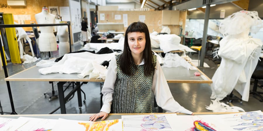 Emily with her colourful fashion illustration portfolio